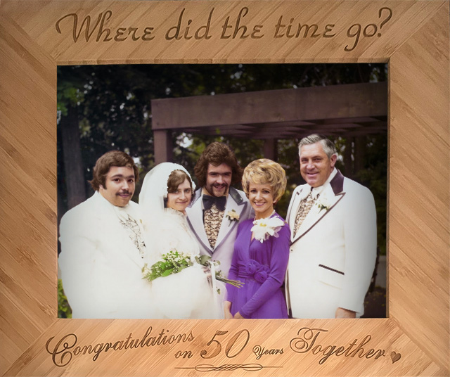 Professionally restored vintage wedding portrait displayed in a custom laser-engraved wooden frame celebrating a couple's 50th wedding anniversary.